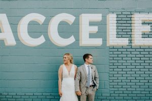 wedding couple against wall at Accelerator Space